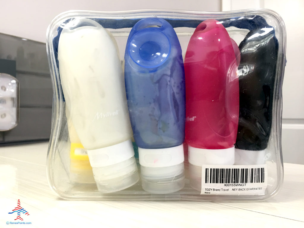 Leakproof, silicone, reusable toiletry tubes are seen in a Tozy clear toiletry bag.