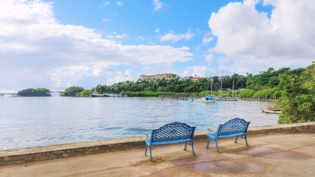 Seaside view of Santa Barbara de Samana bay with walking bridge and boats. Whale watching tourist tour