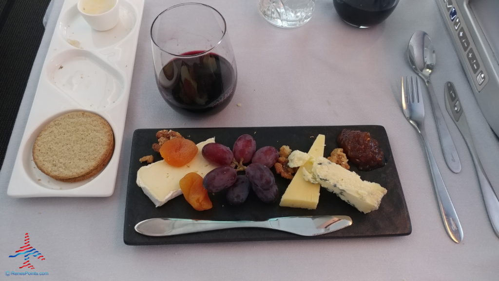 a plate of cheese and grapes