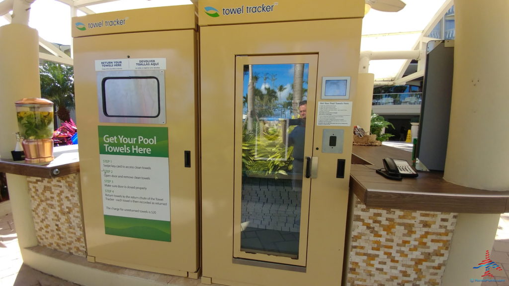 a person standing in a pool towel tracker