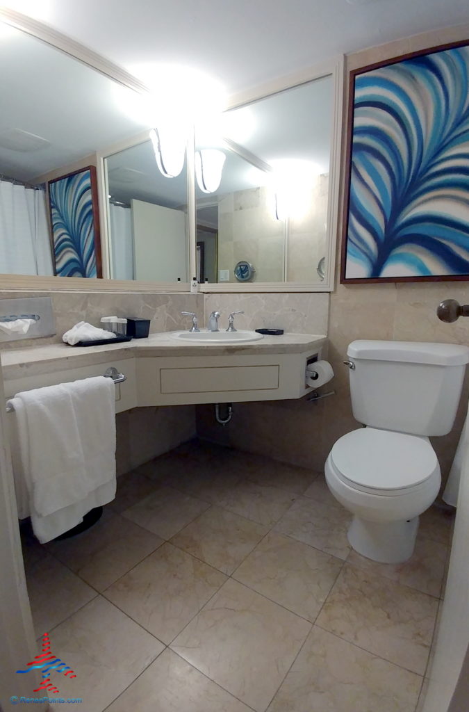 a bathroom with a mirror and a toilet