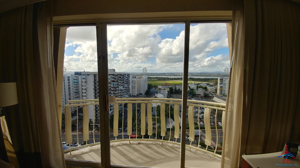 a balcony with a view of a city and buildings