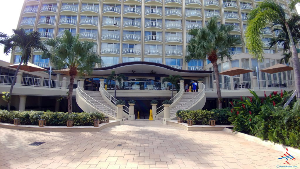 a building with palm trees and stairs