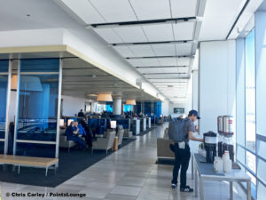 A guest serves himself illy coffee at the United Club LAX airport lounge in Los Angeles, California. © Chris Carley / PointsLounge.