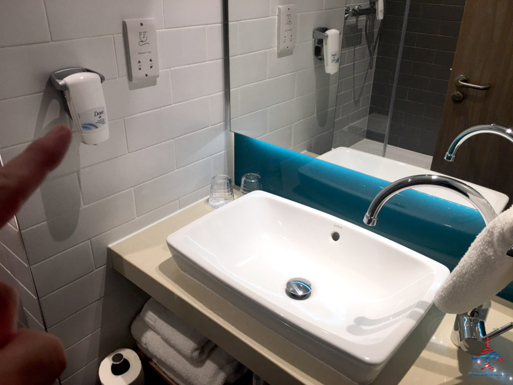 The bathroom sink and hand soap dispenser are seen inside a room at the Holiday Inn Express London Heathrow T4 (LHR airport hotel) in Hounslow, United Kingdom.