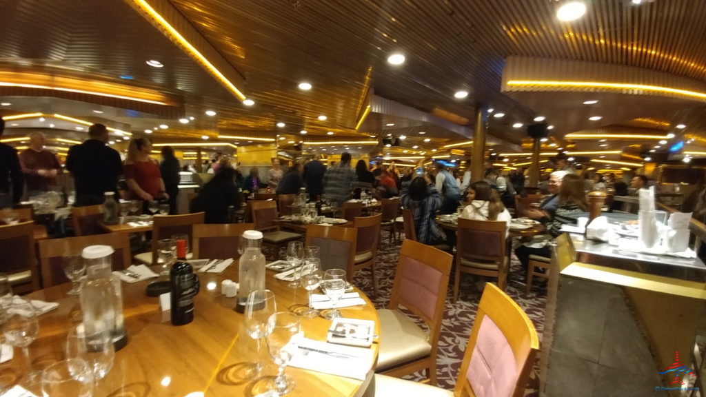 a group of people sitting at tables in a restaurant