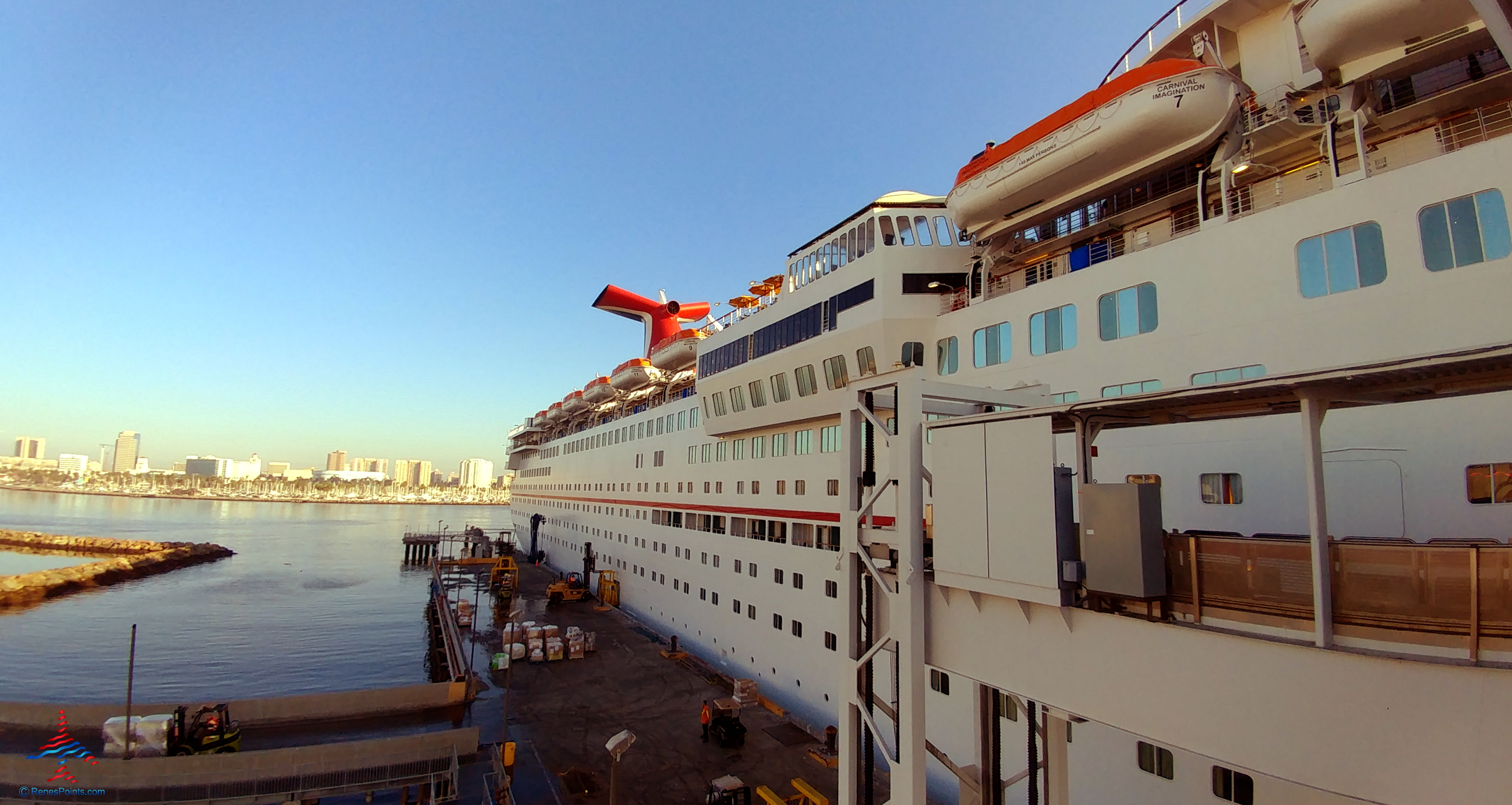 a large white ship with a red roof on the side