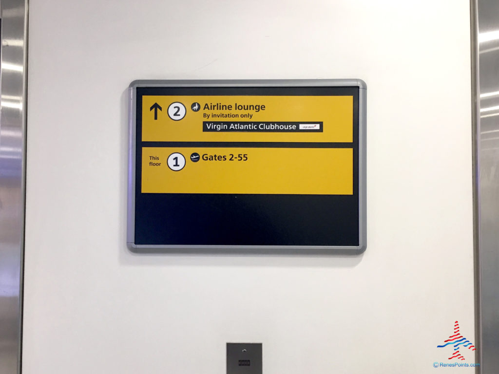 Signage outside an elevator/lift directs guests to the Virgin Atlantic Clubhouse airport lounge at London Heathrow Airport (LHR).