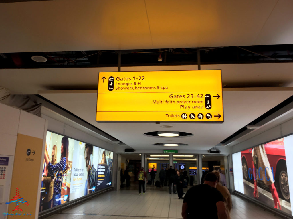 Signage in Terminal 3 directs guests to the Virgin Atlantic Clubhouse airport lounge at London Heathrow Airport (LHR).