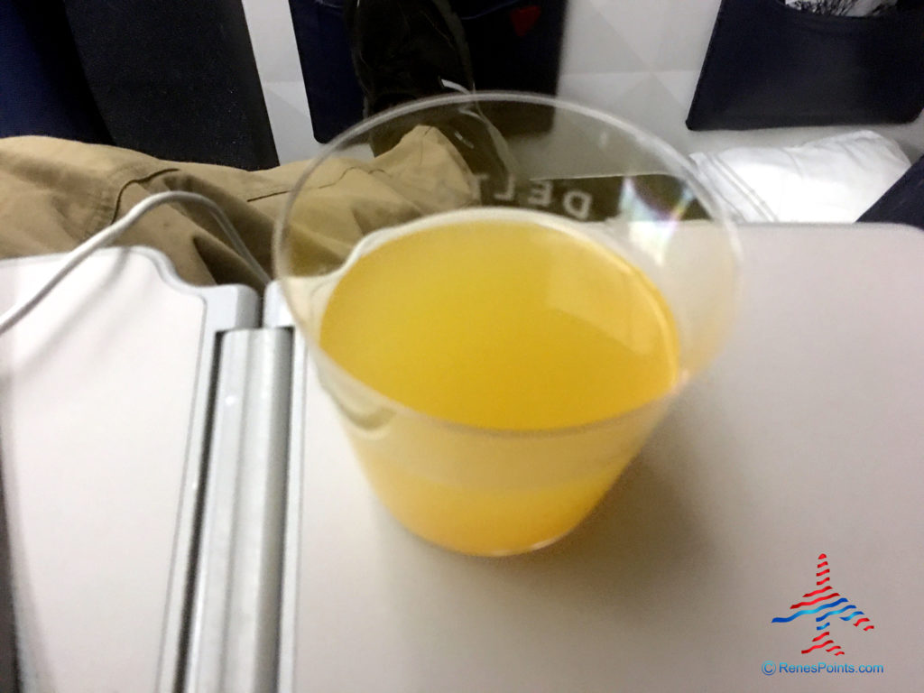 a glass of orange juice on a table
