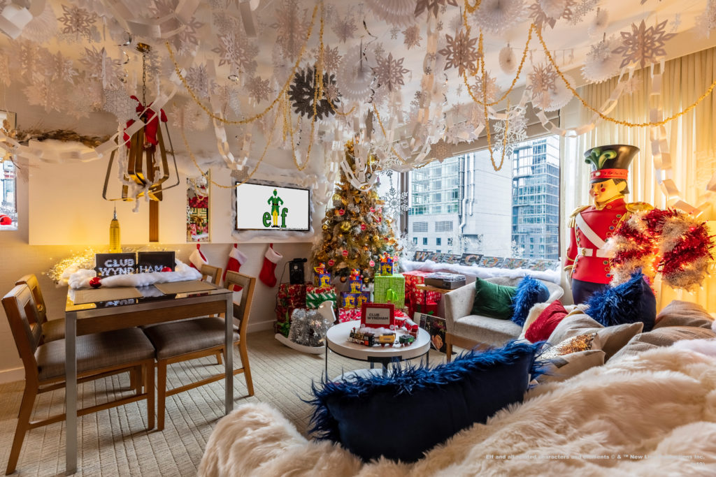 a living room with a christmas tree and a tv