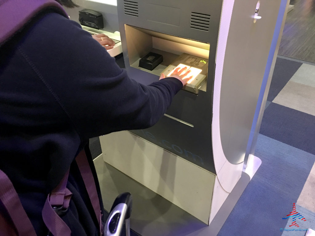A passenger gives a fingerprint sample while enrolling for CLEAR at Las Vegas McCarran International Airport (LAS).