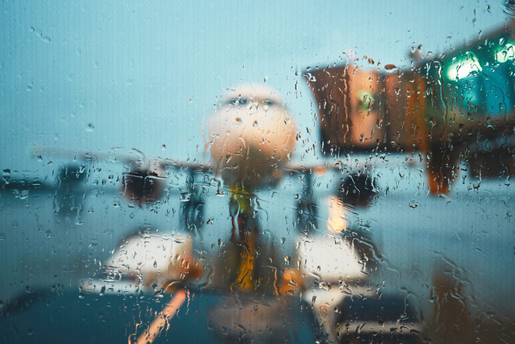 A busy airport in the rain. Push back of the airplane before flight.