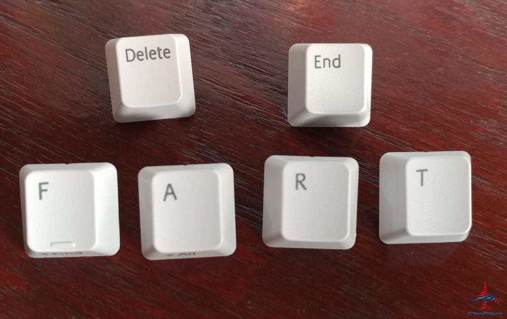 a group of white keys on a wood surface