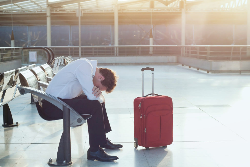 problem with transportation, delay of flight, depressed commuter with his luggage