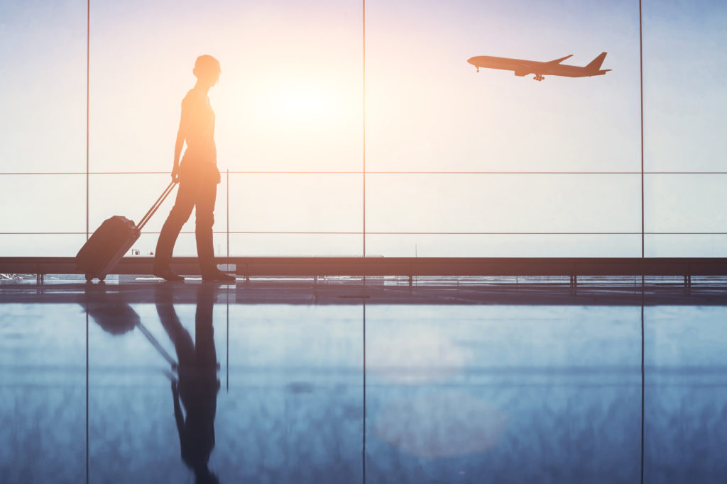 people traveling, silhouette of woman passenger with baggage in airport