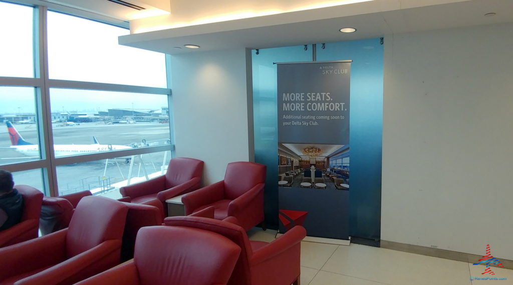 a room with red chairs and a sign