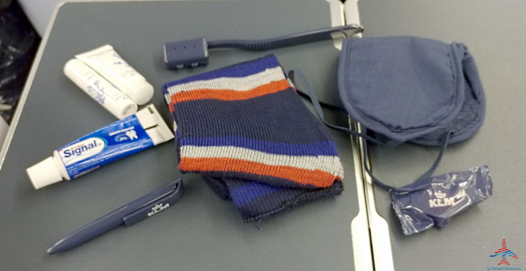 a blue and orange striped scarf and other items on a grey surface