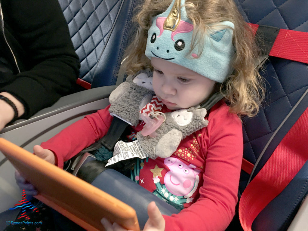 A toddler watches a show on her tablet during a Delta Air Lines flight.
