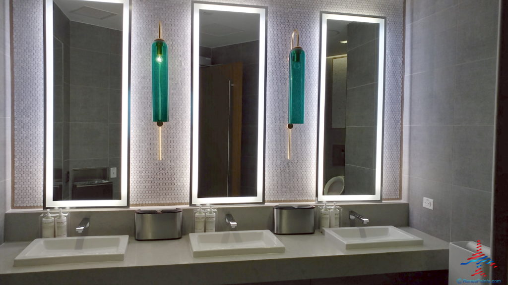 a bathroom with sinks and mirrors