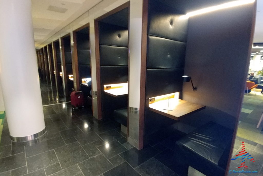 a row of rows of black and white walls with a table and chairs