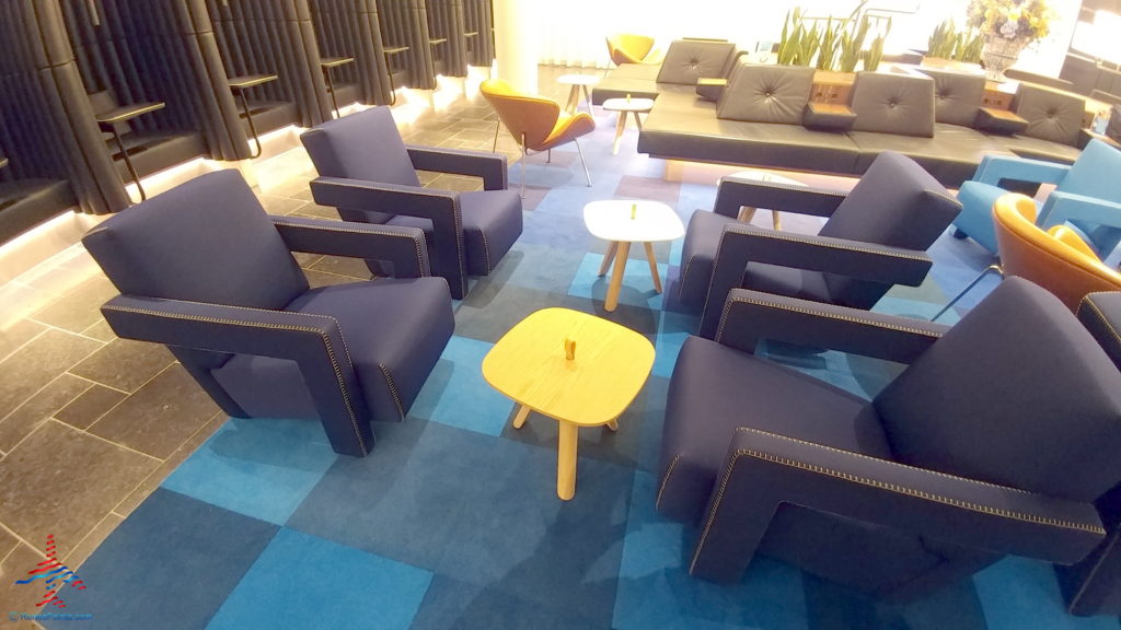 a group of chairs and tables in a room