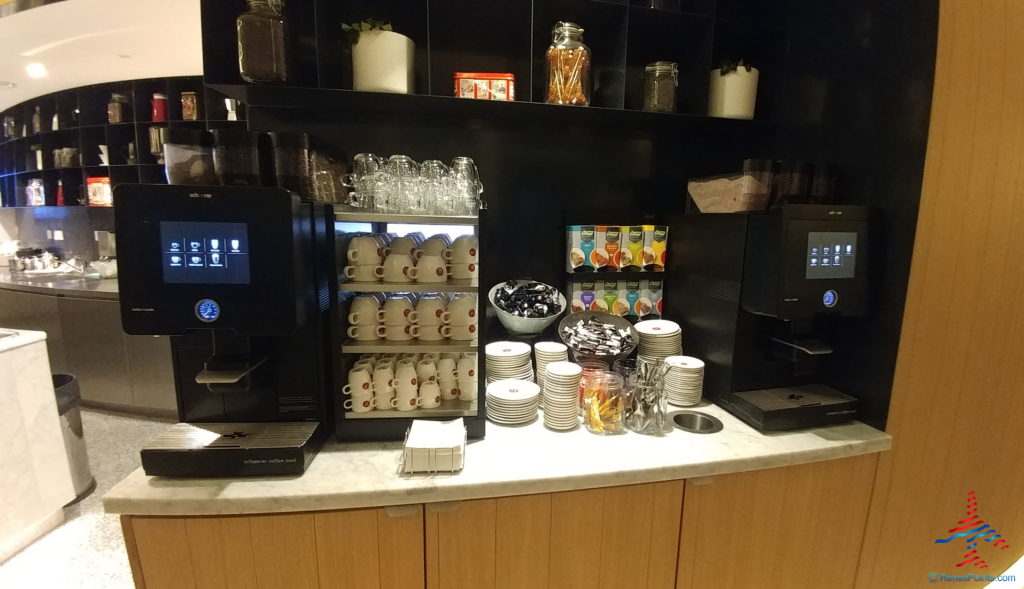 a coffee machine and cups on a counter