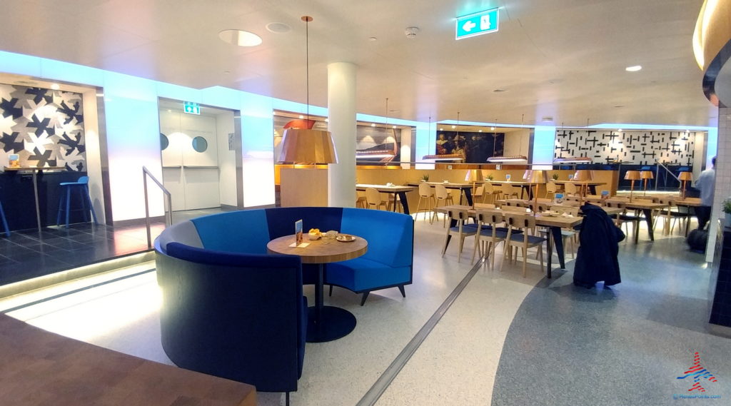 a room with a blue couch and tables