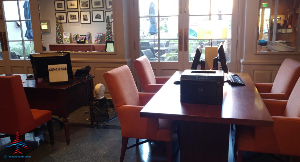 a desk with chairs and a printer on it