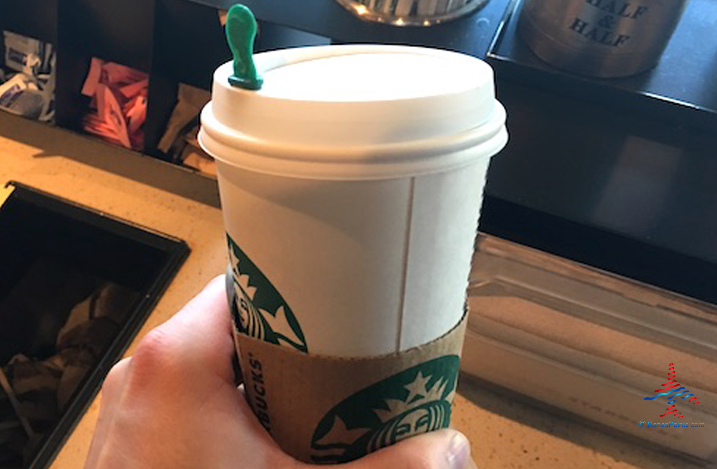 Starbucks coffee cup in hand