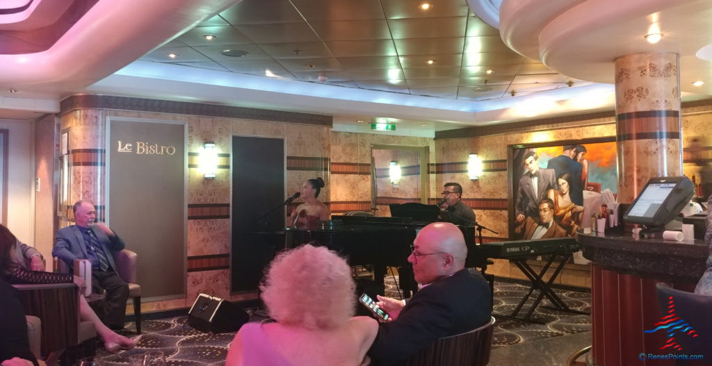 a group of people playing piano and a woman sitting in a room