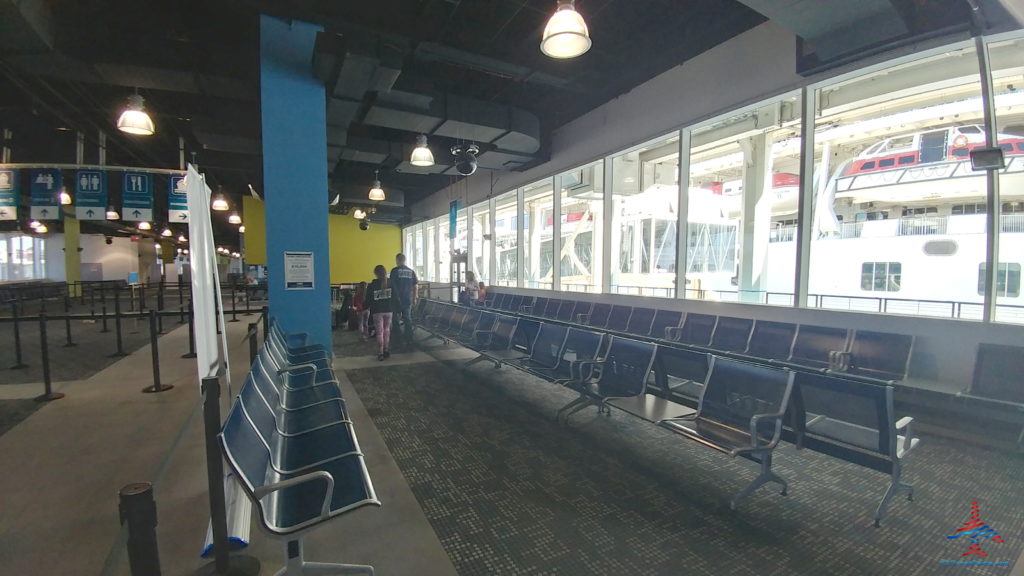 a group of people standing in a row of chairs