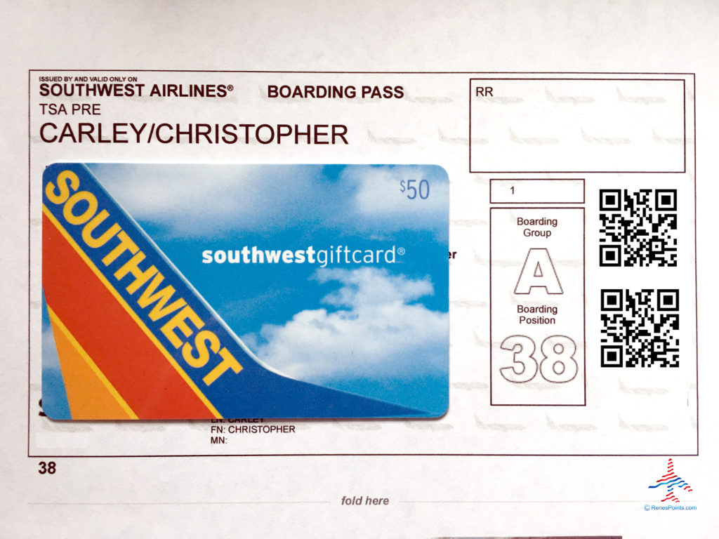 A Southwest gift card is seen stop a Southwest Airlines boarding pass.