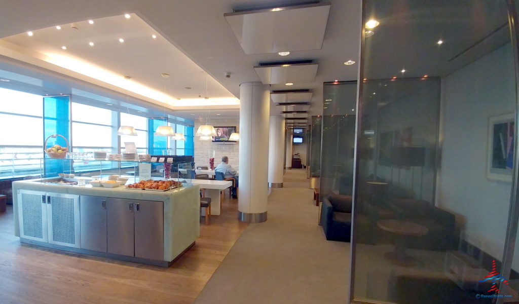 a food court with a man sitting at the table