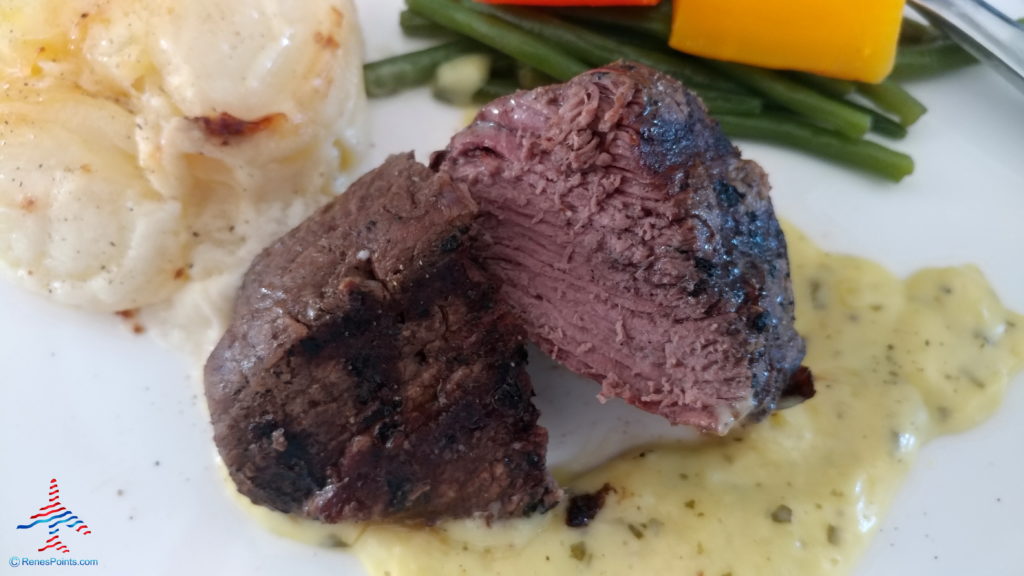 a plate of food with a piece of meat and vegetables