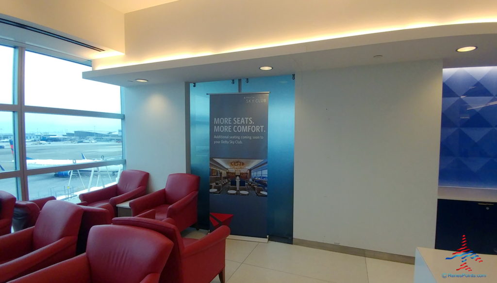 a room with red chairs and a sign