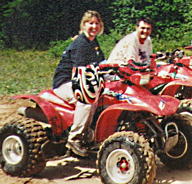 a man and woman on a four wheeler