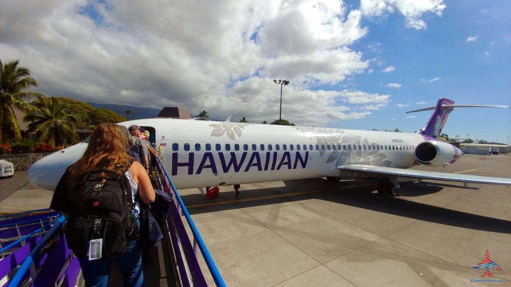 people standing next to a plane