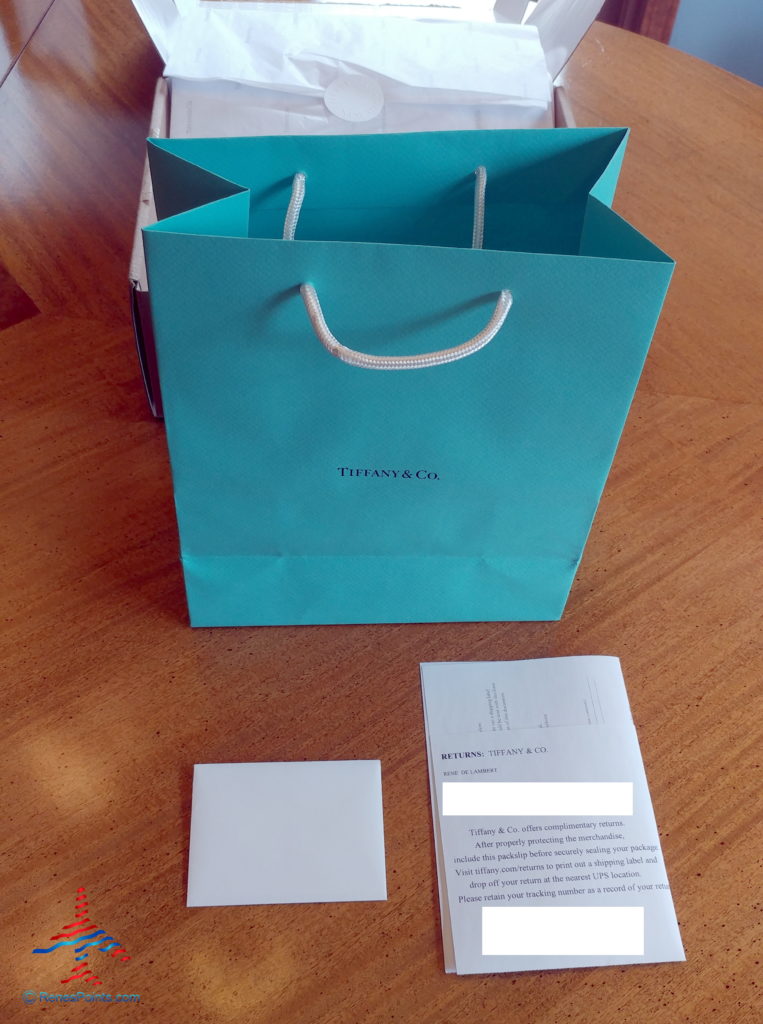 a blue bag next to a white envelope