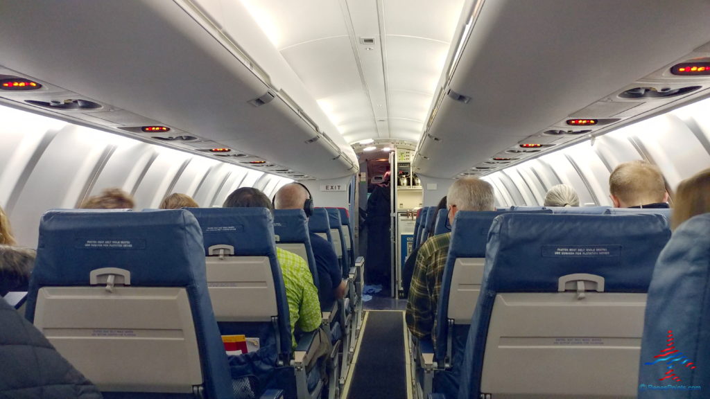 a group of people sitting in an airplane