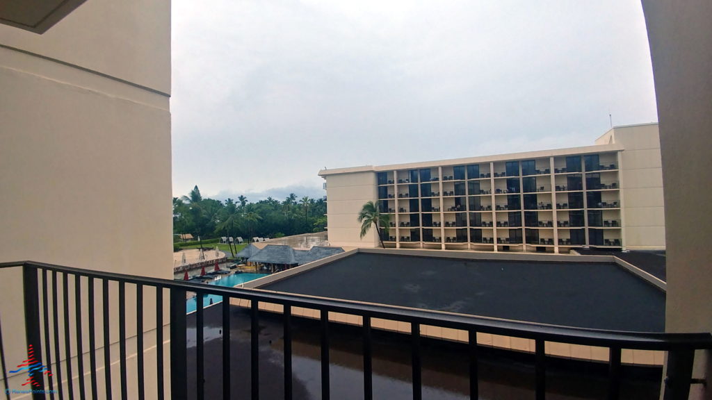 a balcony with a building and a pool