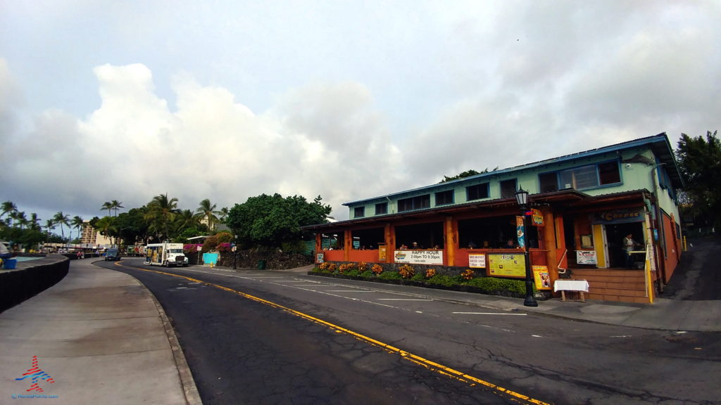 a street with a building and trees