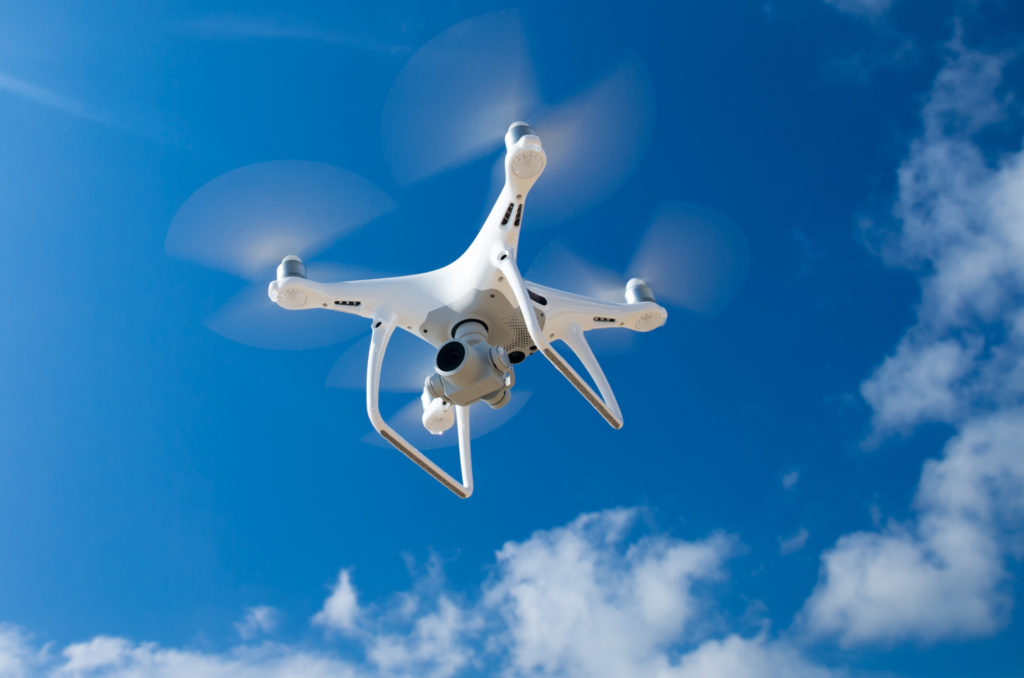 A drone flies in the blue sky (©iStock.com/Pakhnyushchyy)