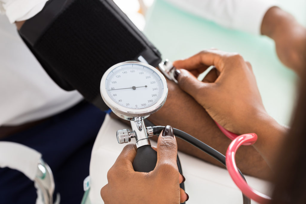 Medical patient having blood pressure taken at the doctor's office