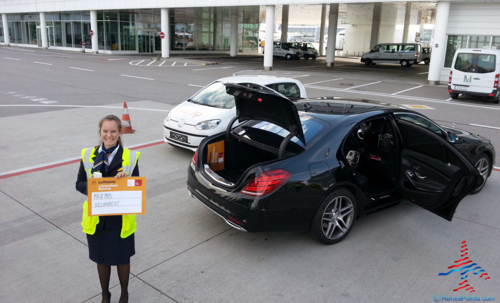 a woman holding a sign next to a car