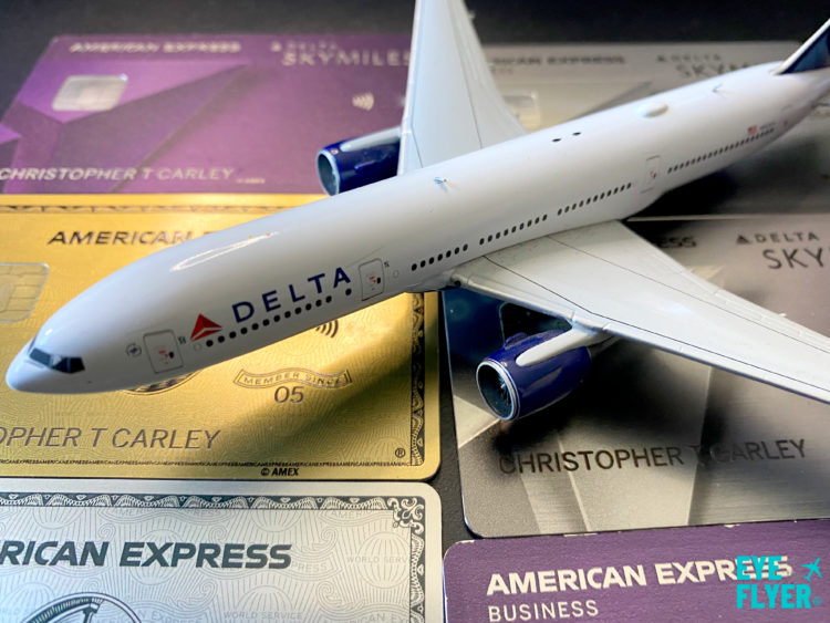 A model Delta Air Lines jet positioned atop American Express cards.