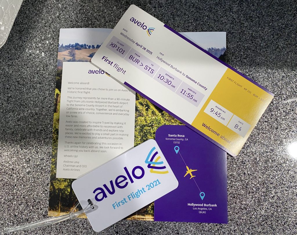 A souvenir boarding pass, boarding pass jacket, and a luggage tag commemorate Avelo Airlines’ first passenger flight, XP101. The trip traveled from Hollywood Burbank Airport in Burbank, California (BUR) to Charles M. Schulz–Sonoma County Airport in Santa Rosa, California (STS) on Wednesday, April 28, 2021.