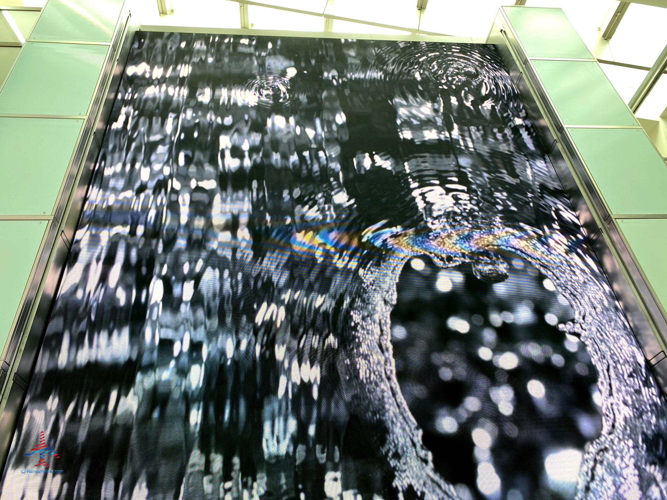 A digital mural displays art near the American Express Centurion Lounge LAX inside the Tom Bradley International Terminal (TBIT) at Los Angeles International Airport in Los Angeles, CA. (©Chris Carley/RenesPoints.com)