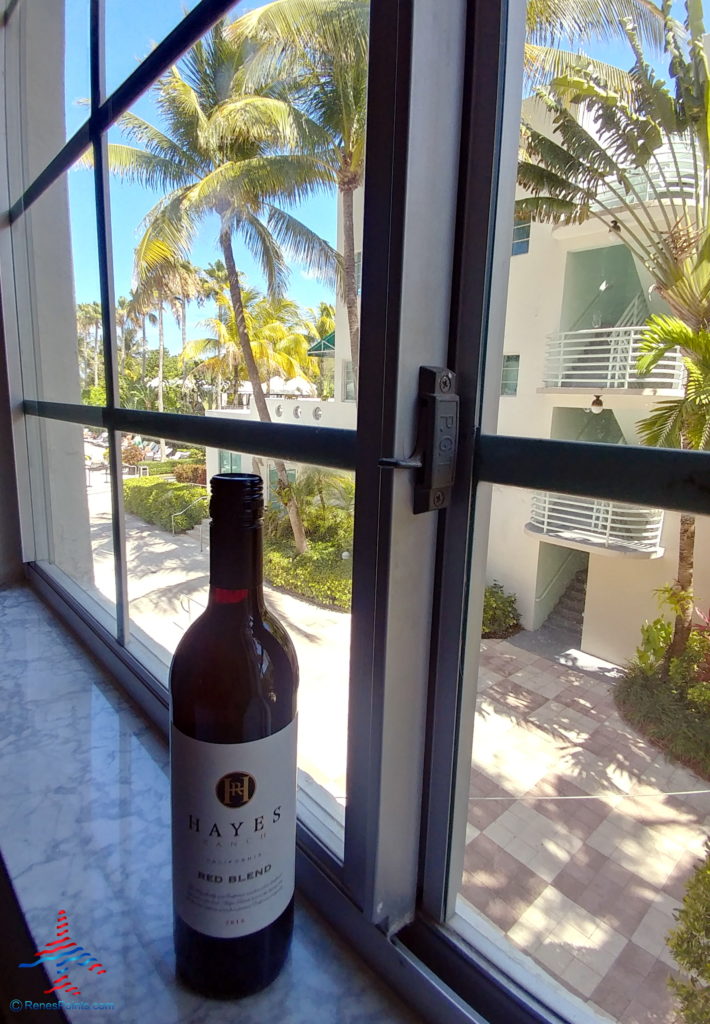 a bottle of wine on a window sill