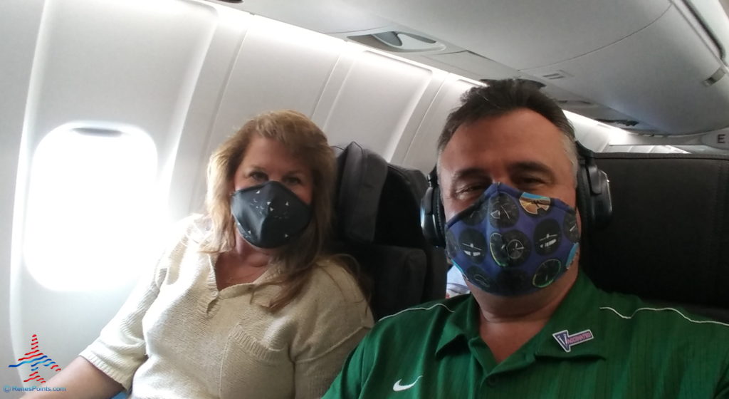 a man and woman wearing face masks